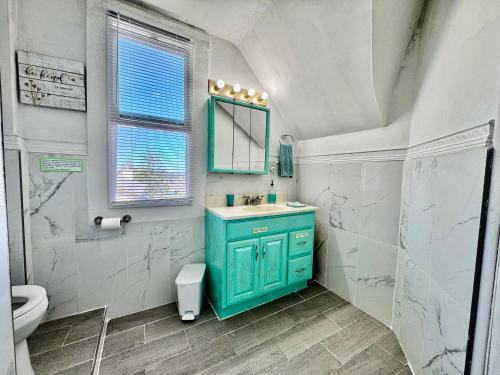 a bathroom with a blue cabinet and a sink at Private Room with Shared Amenities 10 Minutes to Airport and Walking Distance to Bus Station in Seattle
