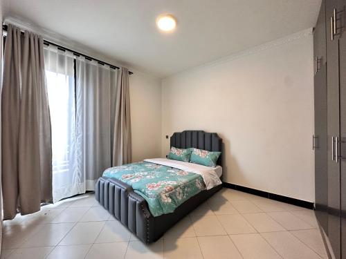 a bedroom with a bed and a large window at Luxury Living in Bunga, Ggaba Road Kampala in Munyonyo