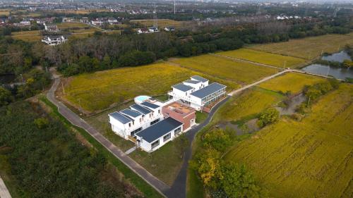 an aerial view of a large white house with a roof at Xutang (Yang Zhou) hot spring Boutique Hotel&Resorts in Jiangdu