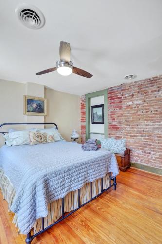 a bedroom with a bed and a brick wall at Historic Downtown Gettysburg Entire Home with Free Parking in Gettysburg