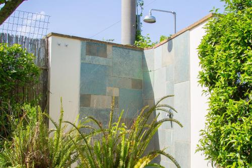 a building with a wall with plants in front of it at LA CESA Holiday House in San Felice Circeo