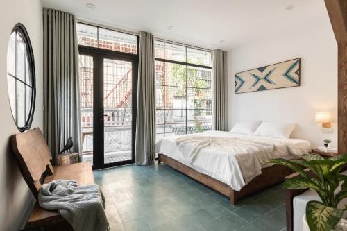 a bedroom with a bed and a large window at Lakeside Horizon Boutique Suites-1 min to Hoan Kiem Lake-Free Airport in Hanoi