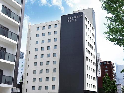 a building with a sign on the side of it at FUN GATE HOTEL Sapporo in Sapporo