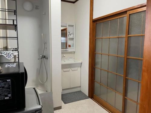 a bathroom with a shower and a glass door at D-pdal Inn - Vacation STAY 39054v in Tokyo
