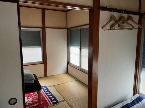 a room with a door and a room with windows at D-pdal Inn - Vacation STAY 39054v in Tokyo