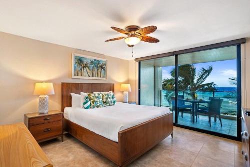 a bedroom with a bed and a view of the ocean at Mahana 307 · MA 307 OceanFront Condo w Pool AC in Kahana