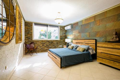 a bedroom with a bed with a wooden headboard at A 4 floors house with a large capacity in Los Cristianos