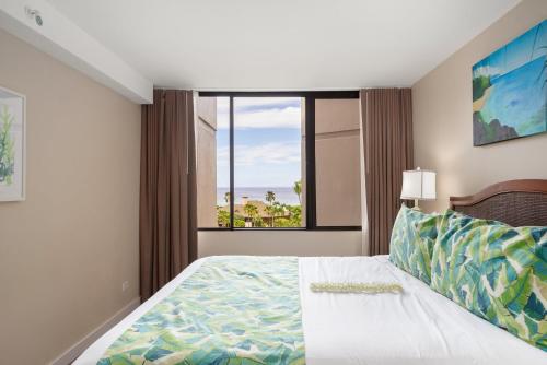 a bedroom with a bed and a large window at Kaanapali Shores 527 · KS 527 2Bedroom w Ocean Views in BeachFro in Kahana