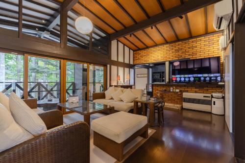 a living room with a couch and a table at T&A Resort&Sauna KARUIZAWA in Miyota