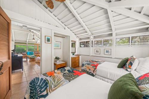 a bedroom with two beds and a living room at International Colony Club 34 · ICC 34 Spacious 2BD Cottage w Poo in Lahaina