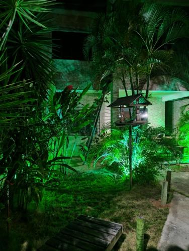 a garden at night with green lights at Casa Temporada in Porto Seguro