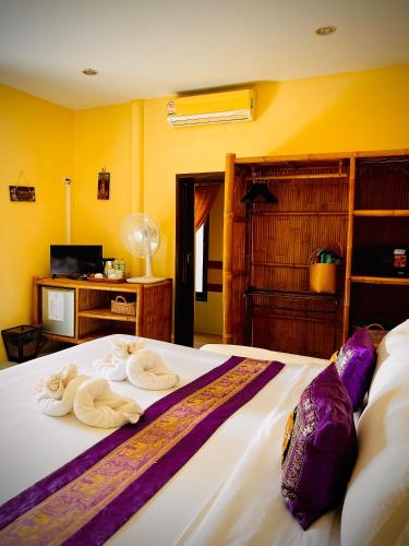 a bedroom with a bed with towels on it at Baan Ton Rak Boutique Resort in Ko Chang