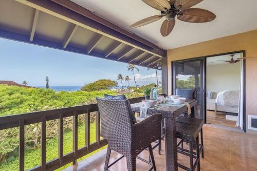 a balcony with a table and chairs and the ocean at Kaanapali Plantation 58 · KPL 58 Spacious 2BD Plantation Home Ne in Lahaina