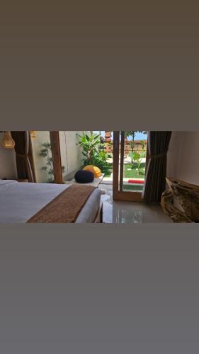 a view of a bedroom with a bed and a window at The Sangka House in Mendaya