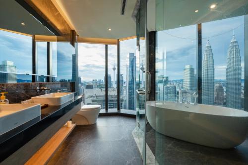 a bathroom with two sinks and a tub and a large window at Imperial Luxury Suites KLCC by Moonway in Kuala Lumpur