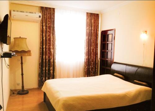 a hotel room with a bed and a window at Leli in Sighnaghi