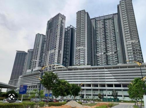 a large building with tall buildings in the background at D Pristine 3 bedroom residence next to legoland in Iskandar Puteri