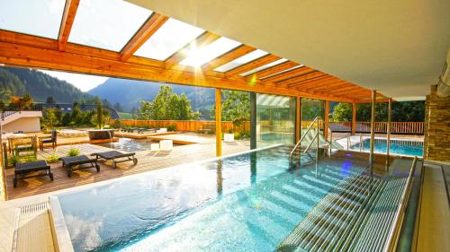 a swimming pool with a view of the mountains at Hotel NockResort in Bad Kleinkirchheim