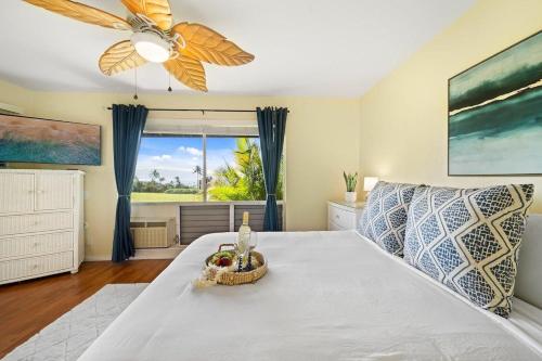 a bedroom with a large bed with a ceiling fan at Kaanapali Plantation 10 · KPL 10 Panoramic Ocean Views 2BD near in Lahaina