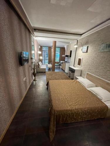 a hotel room with two beds and a living room at Apatcomplex Diva &restaurant&bar in Saints Constantine and Helena