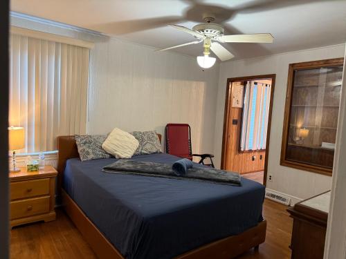 a bedroom with a bed with a ceiling fan at Master Bedroom with Attached SunRoom and Attached Patio in Richmond