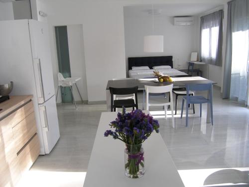 a living room with a vase of purple flowers on a table at Apartments Mon Amour in Dubrovnik