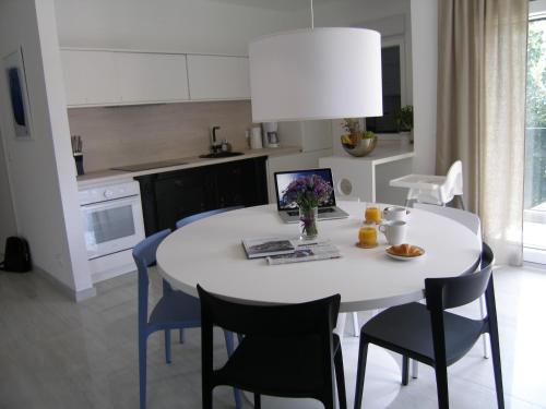 a kitchen with a white table and blue chairs at Apartments Mon Amour in Dubrovnik