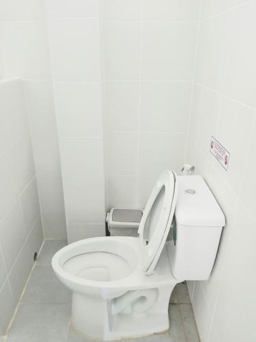 a white bathroom with a toilet with the lid up at Baan Cozy Boutique Natural Wellness Chiang Mai in Chiang Mai