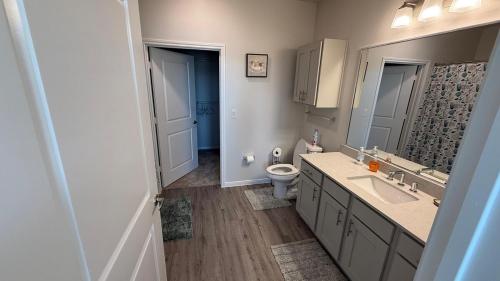 a bathroom with a sink and a toilet in it at Oasis Lakeside place Near Frisco 2bd-2ba Sleep 6 in Aubrey