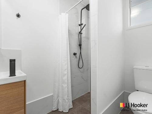 a shower with a shower curtain in a bathroom at Margies in Iluka
