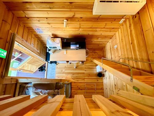 an inside view of a room with wooden walls and benches at i GARDEN in Minami Alps