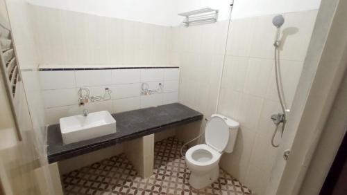 a small bathroom with a toilet and a sink at House of A Syariah Kedamaian in Bandar Lampung