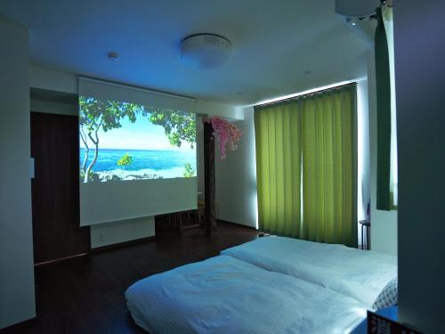 a bedroom with a large window with a large screen at Newly built house in Ota Ward,6 minutes from the station in Tokyo