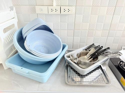 a strainer in a blue tray next to a sink at The Ocean Pool Villa HuaHin in Hua Hin
