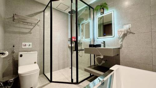 a bathroom with a shower and a toilet and a sink at Sunrise Mountain View Resort in Vang Vieng