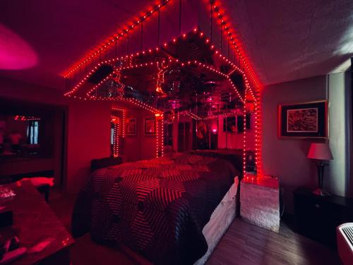 a bedroom with a bed covered in red lights at Executive Inn Coopersburg in Coopersburg