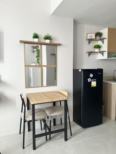 a small kitchen with a table and a refrigerator at Casa Mira Mandaue unit 608 Tower 4 in Cebu City