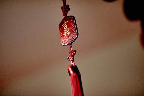 a red candle with chinese writing on it at Pałac Bażantarnia in Pszczyna