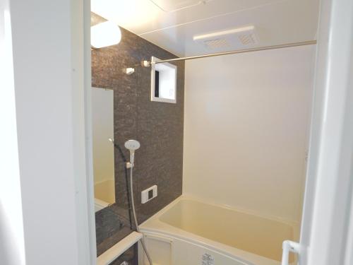 a bathroom with a tub and a shower in it at Newly built house in Ota Ward,6 minutes from the station in Tokyo