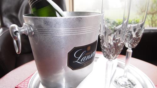 a bucket with a bottle and two wine glasses on a table at The Hotel Balmoral - Just for Adults in Torquay