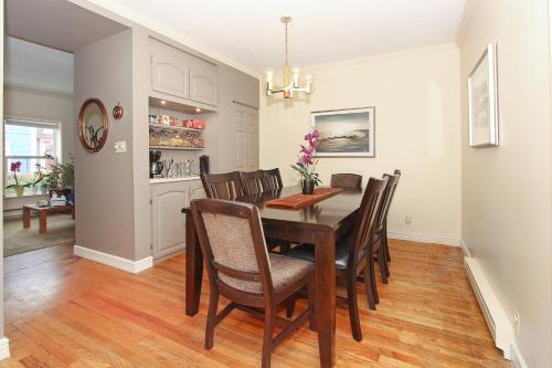 a dining room with a table and chairs at Gower Guest House in St. John's