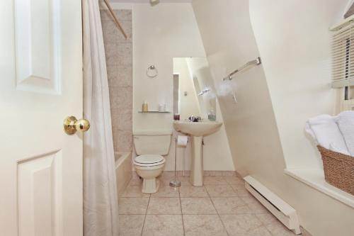 a bathroom with a toilet and a sink at Gower Guest House in St. John's