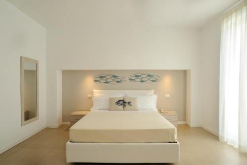 เตียงในห้องที่ Residence San Marco Suites&Apartments Alassio