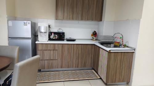 a small kitchen with a sink and a refrigerator at MZS Studio Swiss Garden R in Kuantan