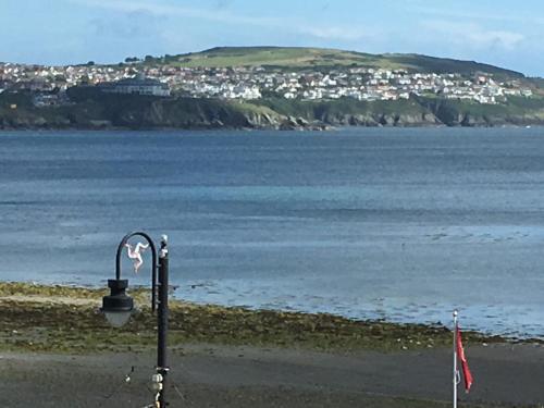 a street light on the beach next to the water at Cubbon House in Douglas