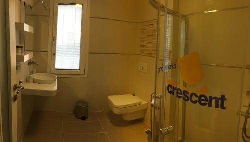 a bathroom with a toilet and a sink and a shower at Crescent Twins -White Villa in Dalyan