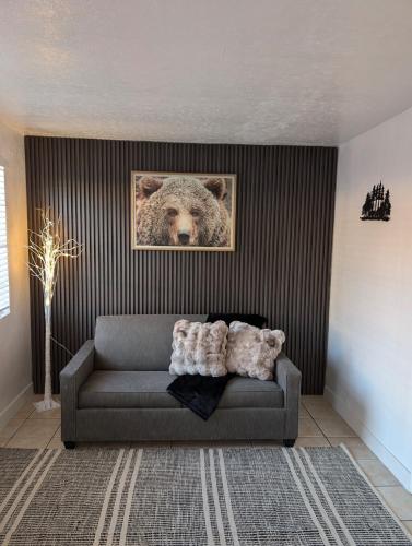 a living room with a couch with a picture of a bear at Bear cave in Tucson