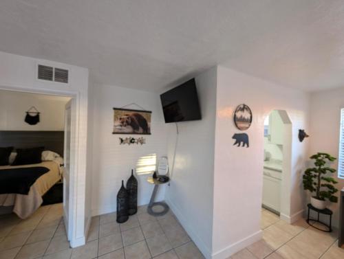 a bedroom with a bed and a tv on a wall at Bear cave in Tucson