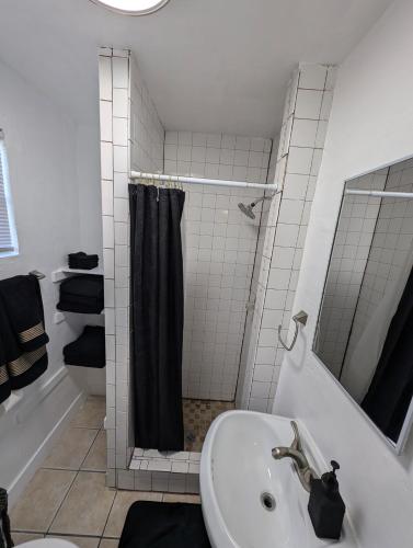 a bathroom with a sink and a shower with a shower curtain at Bear cave in Tucson