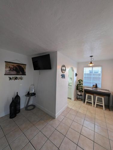 a living room with a television and a table at Bear cave in Tucson